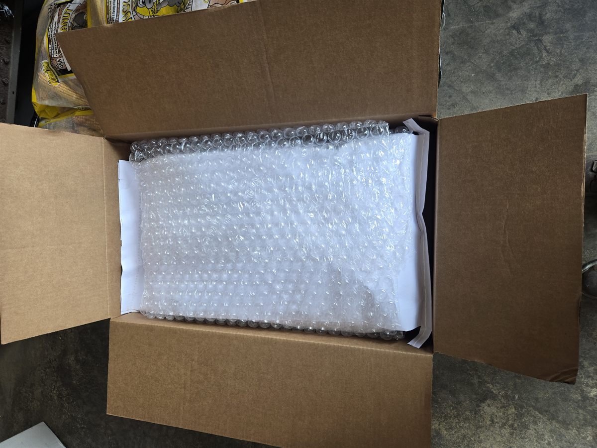 Open Theo's Farm shipping box with protective bubble wrap inside